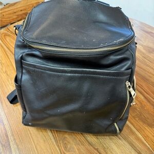 Azaria La Mère black faux leather diaper bag backpack.